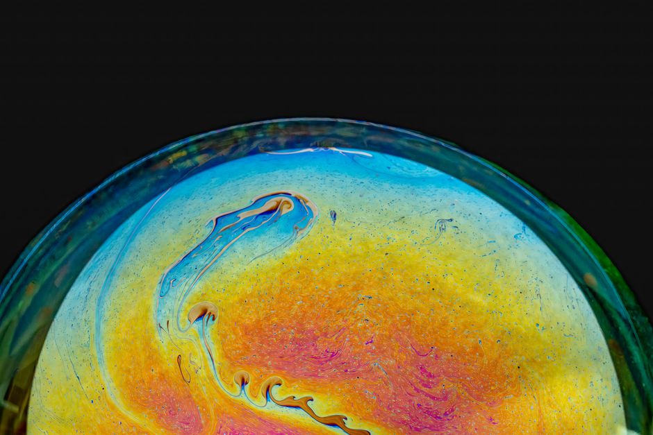 Decoding Iridescence: How Thin-Film Coatings Alter the Surface of Mystic Topaz